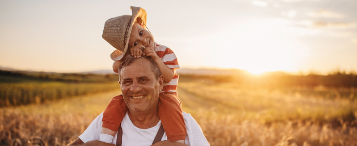 Grandfather with his grandson on their farm