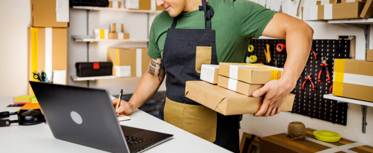 Busy man prepares packages for customers