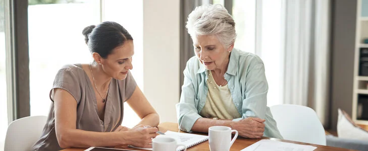 Older woman sitting with estate planning attorney