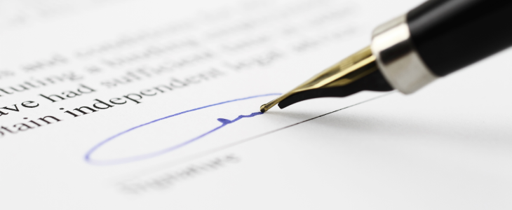 Premarital agreement getting signed by married couple